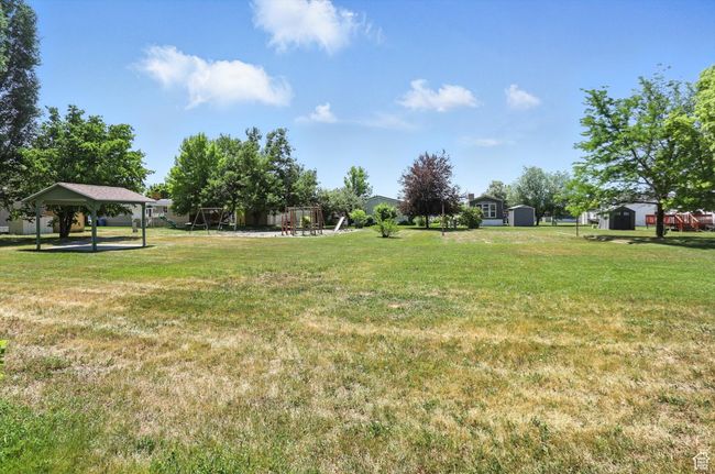 View of grassy yard with a gazebo and a storage shed | Image 22