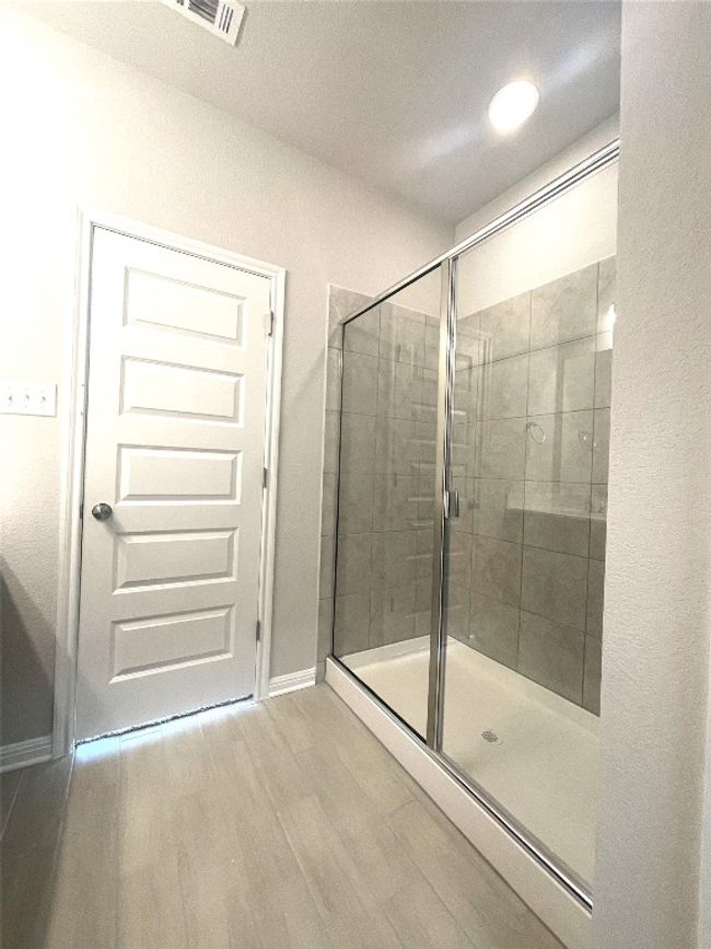 Full bath with a shower stall and wood finished floors | Image 15