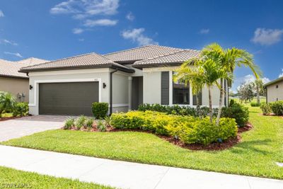 View of front of house featuring a garage and a front lawn | Image 1