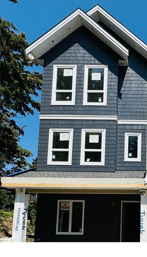Multi-level exterior with horizontal siding in varying tones | Card Image