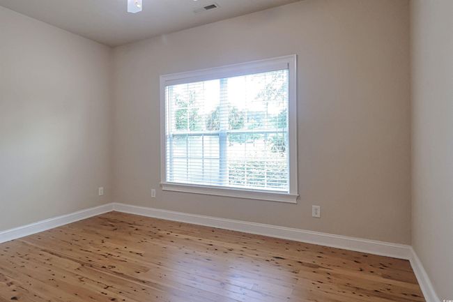 Spare room with wood finished floors and baseboards | Image 17