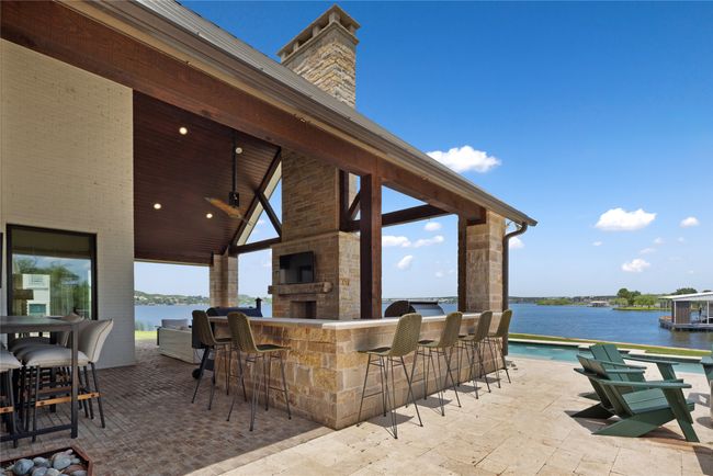 View of patio featuring area for grilling, wine cooler, and a water view | Image 35