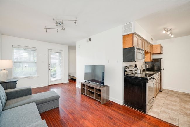 Living room featuring rail lighting, baseboards, and light wood finished floors | Image 31