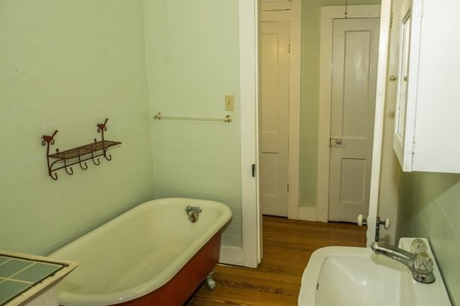 Bathroom with wood finished floors and a freestanding bath | Image 18