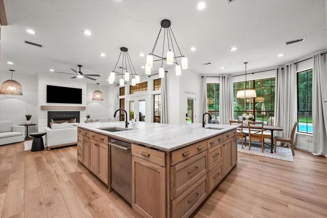 The kitchen awaits just beyond, offering generous cabinetry, built-in storage, and an elegant workspace filled with natural light. | Image 12