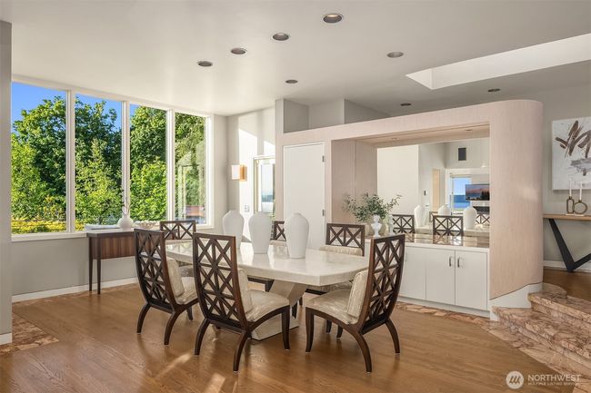 The dining room area opens onto another deck overlooking breathtaking views of Three Tree Point. | Image 9