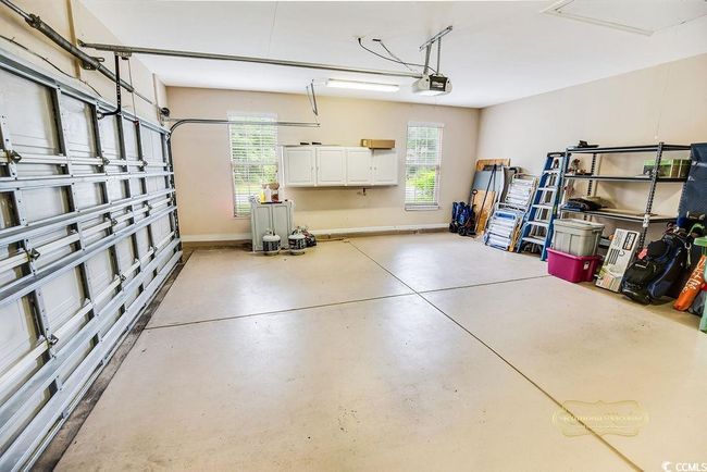 Garage with a garage door opener and baseboards | Image 28