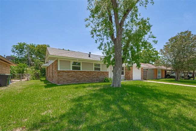A broader view from the side shows the ample setback from the neighboring property, adding privacy and open space. | Image 35