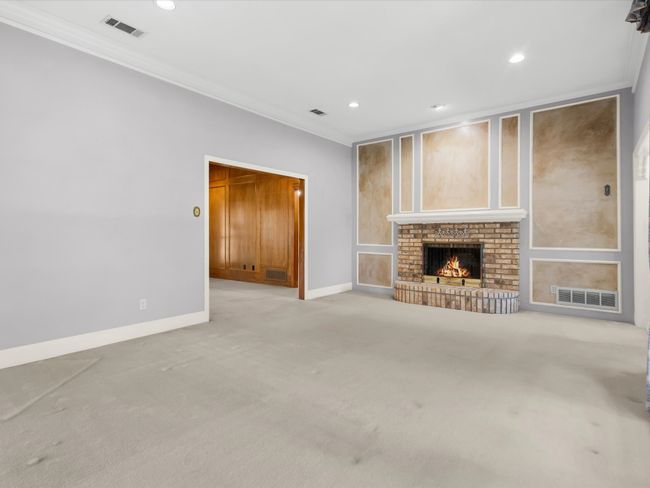 Living Room leads to the den. | Image 9