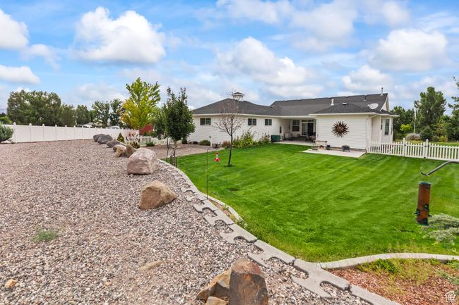 Rear view of house featuring a patio and a fenced backyard | Image 93