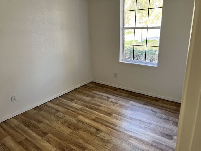Spare room with baseboards and wood finished floors | Image 8