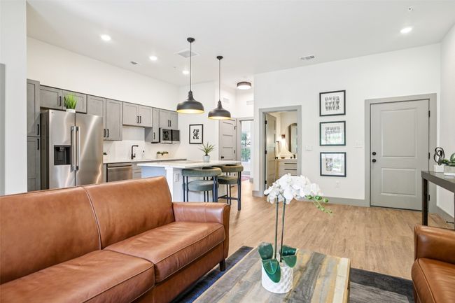 Living area with recessed lighting and light wood-style floors | Image 4