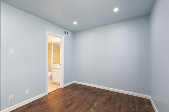 Empty room with recessed lighting, visible vents, baseboards, and wood finished floors | Image 13