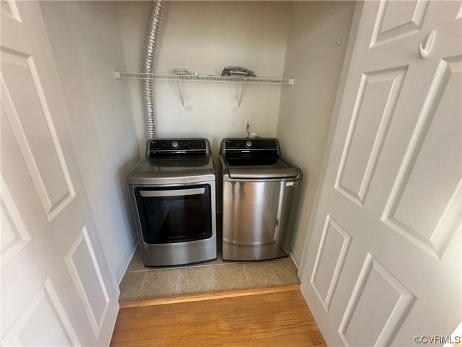 Laundry room with light hardwood / wood-style floors and washer and clothes dryer | Image 22