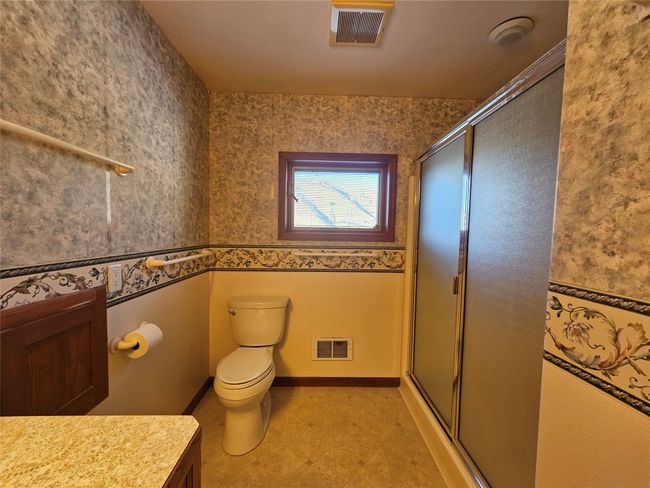 A walk-in shower is a plus in this bathroom - the shower has two shower heads - one a rain shower. | Image 17