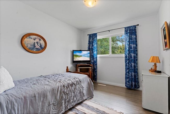 Bedroom featuring wood finished floors and baseboards | Image 18