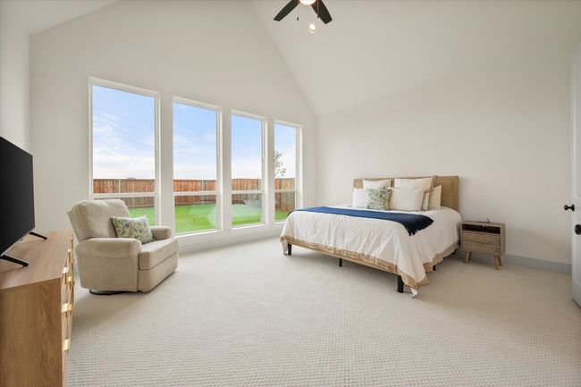 Primary bedroom is oversized with large windows and vaulted ceilings | Image 14