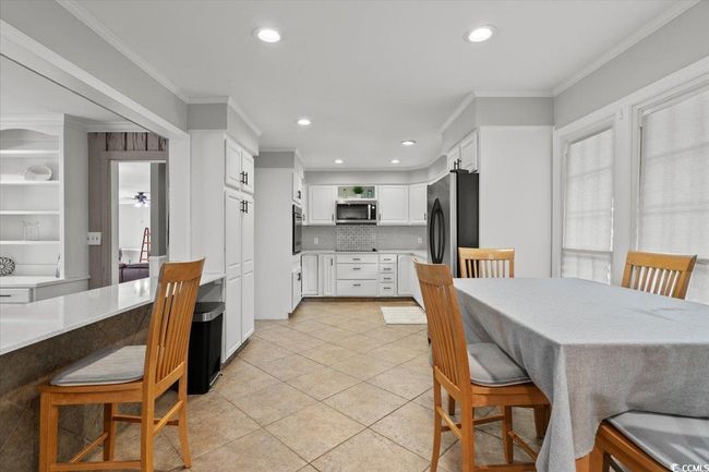 Dining room featuring crown molding, light tile patterned floors, and recessed lighting | Image 14