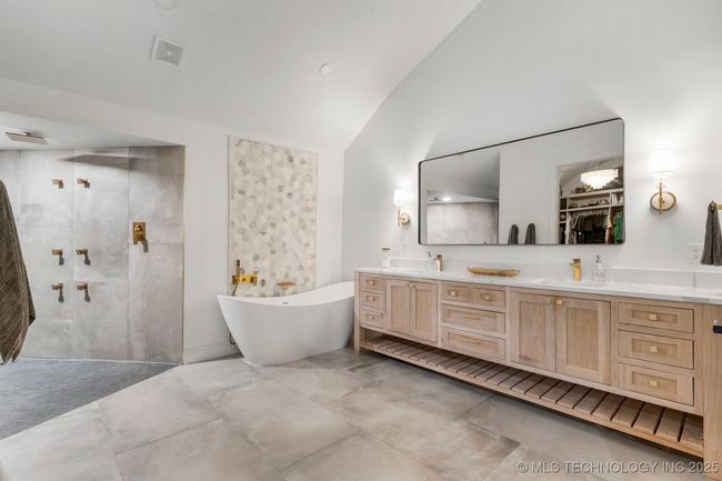 Primary bath with heated floors, dual vanity, separate makeup vanity, and luxury walk-in steam shower with heated floors | Image 46