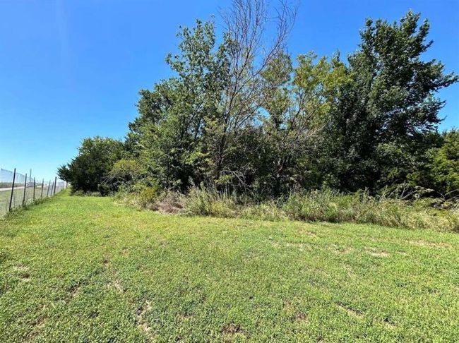 View of yard featuring a rural view and fence | Image 6