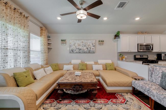 Living room with a ceiling fan and recessed lighting | Image 6