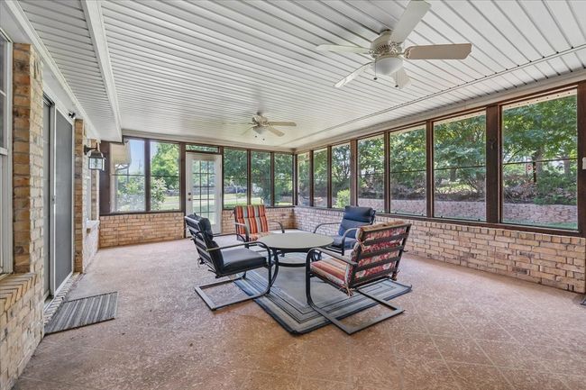 Sunroom with ceiling fan and an outdoor hangout area | Image 24
