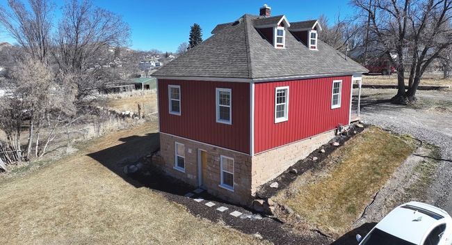 View of property exterior with roof with shingles and a lawn | Image 37