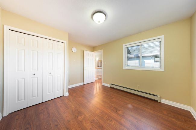 Unfurnished bedroom featuring baseboards, a closet, wood finished floors, and a baseboard heating unit | Image 27