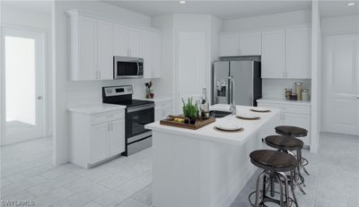 Kitchen featuring an island with sink, stainless steel appliances, and white cabinetry | Image 2