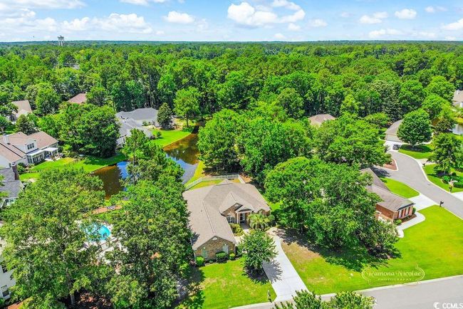 Drone / aerial view of a heavily wooded area and a large body of water | Image 34