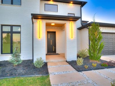 Exterior entry at dusk with a garage | Image 2