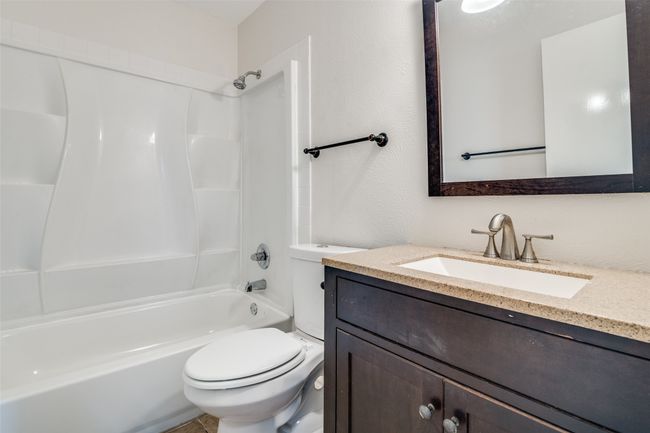 Full bath featuring vanity and bathing tub / shower combination | Image 19