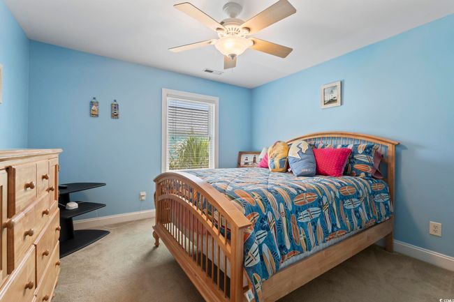 Bedroom with carpet flooring, baseboards, and ceiling fan | Image 29