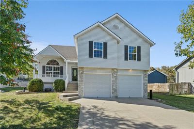 View of front of home with a front yard and a garage | Image 2