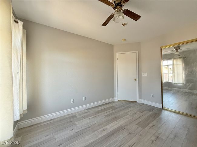 Spare room with baseboards, light wood finished floors, and ceiling fan | Image 34
