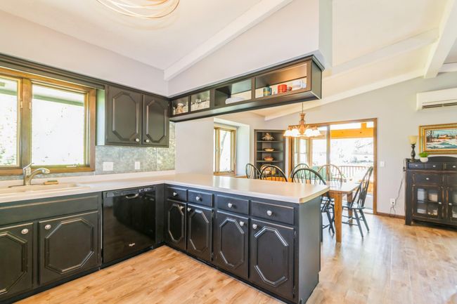Kitchen and dining room open up to the 3 season porch. | Image 18