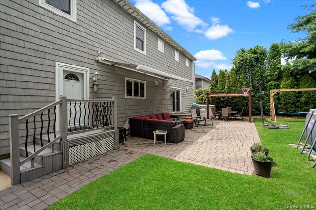 View of patio with an electric awning for an outdoor hangout area | Image 22