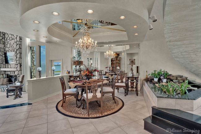 Tiled dining space with a chandelier, a raised ceiling, ornamental molding, and recessed lighting | Image 6