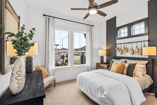 Bedroom featuring carpet flooring, a barn door, and ceiling fan | Image 5