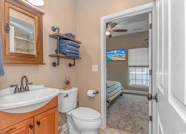 Bathroom with vanity, a ceiling fan, and a shower | Image 20