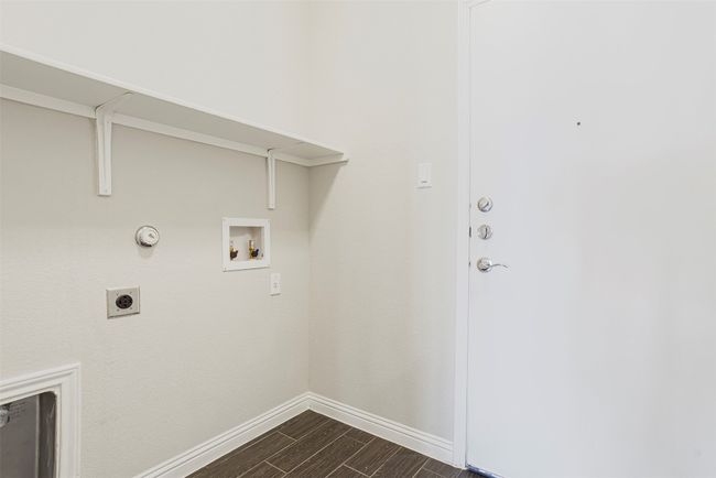 Washroom with wood tiled floors, hookup for a washing machine, hookup for an electric dryer, and hookup for a gas dryer | Image 34
