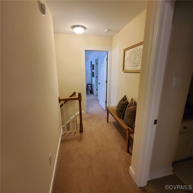 Hallway with an upstairs landing, baseboards, and carpet floors | Image 32