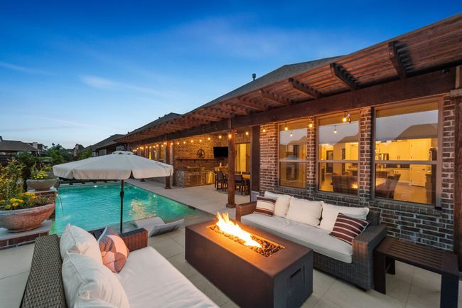 Magazine-worthy backyard with pool, outdoor living space, fire pit and a covered patio | Image 35