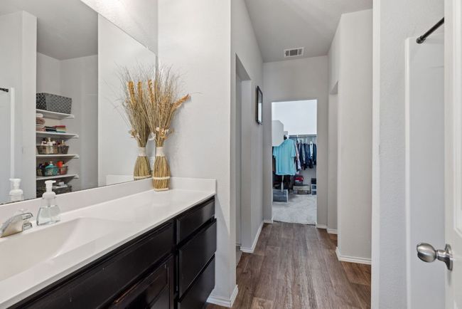 Full bathroom featuring wood-vinyl finished floors, vanity, and baseboards | Image 30