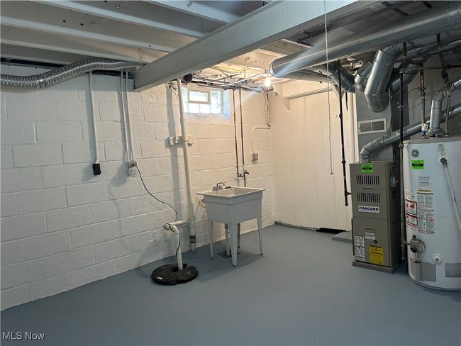 Below grade area with gas water heater and visible vents | Image 39
