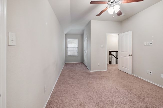 Empty room featuring light colored carpet and a ceiling fan | Image 15