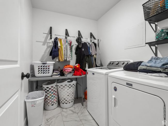 Washroom featuring washer and dryer and light marble finish flooring | Image 24