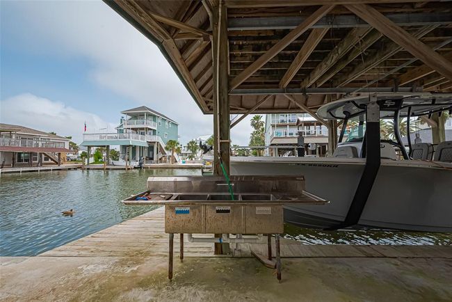 Covered boat dock with a sink, ideal for fishing enthusiasts. | Image 35