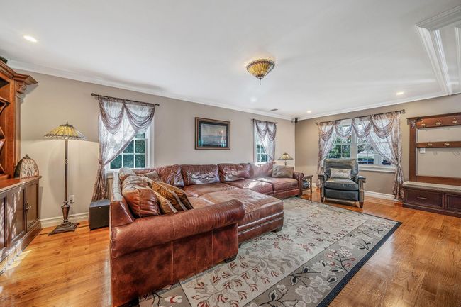 Living area featuring baseboards, light wood-type flooring, and ornamental molding | Image 9