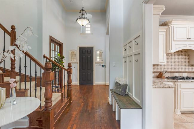 Formal Living room with arched walkways, wood finished floors, crown molding, a chandelier, and recessed lighting | Image 29